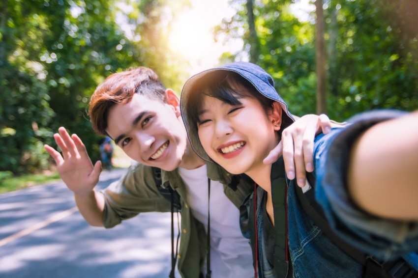 Asian Group of young people with friends and backpacks walking t